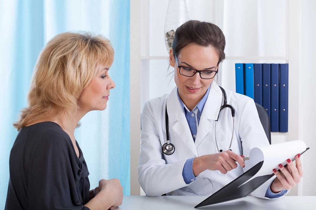 Doctor discussing blood test results with a patient during a health consultation